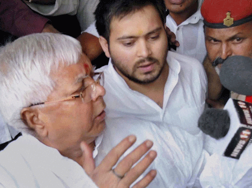 RJD chief and former Bihar Chief Minister Lalu Prasad Yadav talks to reporters as he arrives with his son Tejaswi Yadav at the special CBI court in Ranchi on Monday. The court convicted Lalu in Chaibasa fodder scam. PTI Photo