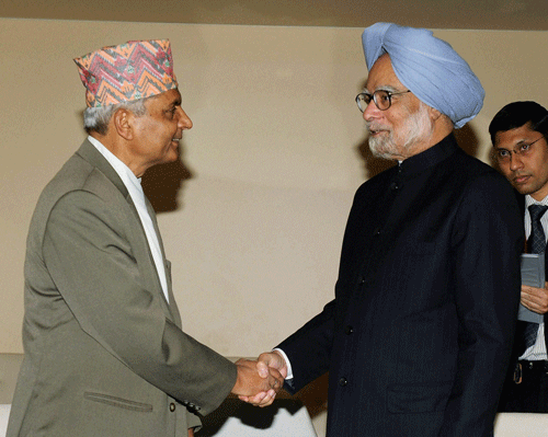 Prime Minister Manmohan Singh greets Chairman of Cabinet of Nepal, Khil Raj Regmi during the 68th session of the United Nations General Assembly at U.N. headquarters in New York on Saturday. PTI Photo