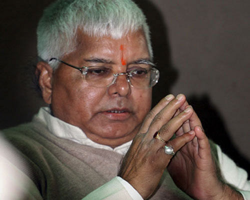 FILE- In this Dec. 18, 2006 file photo, Indian politician Lalu Prasad Yadav gestures as he greets his supporters in Patna, India. Prasad and Jagannath Mishra, two former chief ministers of Indian state Bihar were convicted Monday, Sept. 30, 2013, of embezzling millions of dollars in the 1990s with bogus bills for cattle feed. The verdict in the 15-year-old 'fodder scam' case could make Prasad, now a member of Bihar's opposition and India's parliament, one of the country's first politicians to face political disqualification under a new Supreme Court order banning convicts from holding public office. AP file