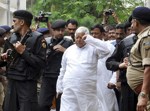 Rashtriya Janata Dal party chief, Lalu Prasad Yadav, center, arrives at a special court held by Central Bureau of Investigation or CBI, for a verdict in the 15-year-old 'fodder scam' case, in Ranchi, India, Monday, Sept. 30, 2013. Prasad and Jagannath Mishra, two former chief ministers of Indian state Bihar were convicted Monday of embezzling millions of dollars in the 1990s with bogus bills for cattle feed. AP Photo