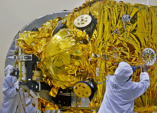 Engineers work on the Mars orbiter spacecraft at the satellite center of Indian Space Research Organization (ISRO) in Bangalore, India, Wednesday, Sept. 11, 2013. India's ambitious US$71,096,000 Mars orbiter mission is scheduled to be launched by Polar Satellite Launch Vehicle (PSLV-C25) between Oct 21 and Nov 19, 2013 from Sriharikota. File AP Photo
