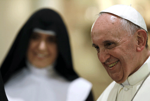 Pope Francis smiles during a meeting with cloistered nuns at the St. Chiara Basilica in Assisi. Reuters