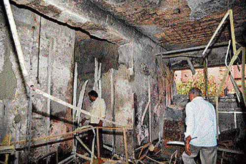 People look at a burnt office of the Superintendent of the Adharshila Observation Homes for Boys II at Kingsway Camp, North Delhi, on Sunday. PTI