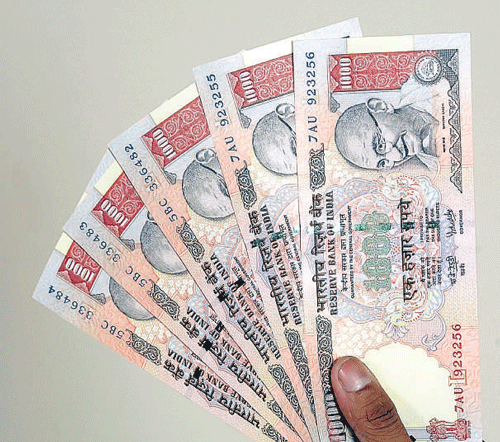Rupee drops 34 paise Vs dollar in late morning deals