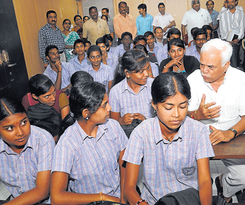 Time to teach: Higher Education Minister R V Deshpande interacts with students at the inauguration of English communication classes for Government Polytechnic Students in the City on Monday. dh photo