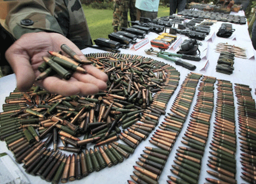 Army displaying arms and ammunition recovered from militants who were killed in recent encounters while trying to infiltrate in the Keran Sector of Jammu and Kashmir, at Army's Badami Bagh headquarters in Srinagar on Monday. PTI Photo