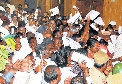 inconvenience: A near stampede was created with a large crowd of people vying  to submit their petitions to the Chief Minister during Janatha Darshan at Kalakshetra building, in Hassan,  on Tuesday. dh photo