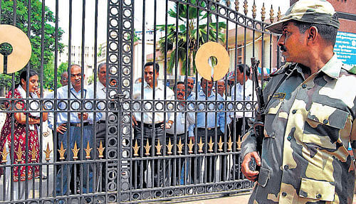 Security personnel stand guard during a protest by SBI employees supporting a united Andhra Pradesh in  Hyderabad on Tuesday. PTI