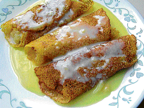 gooey Patishapta is a common sweet dish prepared in Bengali households for festivities.