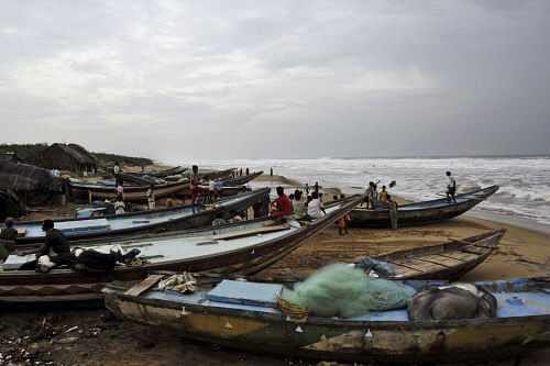 Villagers look at the Bay of Bengal in Gokhurkuda, in Ganjam district , 215 kilometers (136 miles) from Bhubaneswar on Friday, Oct. 11, 2013. The Indian Meteorological Department warned that a massive cyclone Phailin was a 'very severe cyclonic storm' that was expected to hit India's eastern seaboard with maximum sustained winds of 210-220 kilometers (130-135 miles) per hour. (AP Photo/Biswaranjan Rout)