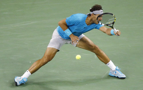 Rafael Nadal of Spain returns a shot to Switzerland's Stanislas Wawrinka during the singles quarterfinal match of the Shanghai Masters tennis tournament at Qizhong Forest Sports City Tennis Center, in Shanghai, China, Friday, Oct. 11, 2013. Nadal won 7-6, 6-1. AP Photo