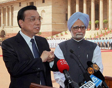 File photo of Chinese Premier Li Keqiang talking to the media as Prime Minister Manmohan Singh looks at Rashtrapati Bhavan. PTI