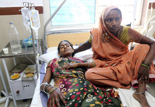 A woman injured in Sunday's stampede on a bridge across the Sindh River lies at a hospital in Datia district, Madhya Pradesh state, India, Monday, Oct.14, 2013. Pilgrims visiting a temple for a popular Hindu festival in India stampeded on fears a bridge would collapse, and more than 100 people were crushed to death or died in the river below, officials said Monday. Scores more were injured, and some bodies may have washed away. AP photo