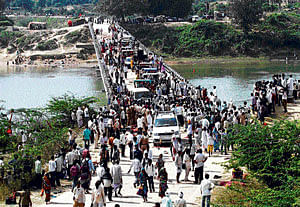 Day after: People cross a bridge that was the spot of a stampede near Ratangarh temple in Datia district in Madhya Pradesh on Monday. REUTERS