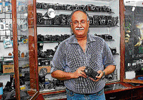 prized possession: Pavan Mehta poses infront of his  collection of old cameras.