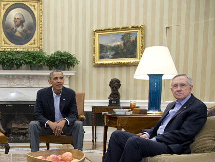 President Barack Obama, left, and Senate Majority Leader Harry Reid of Nev., look to photographers as they meet with Sen. Patty Murray, D-Wash., Sen. Dick Durbin, D-Ill., and Sen. Charles Schumer, D-N.Y., in the Oval Office of the White House, Saturday, Oct. 12, 2013, in Washington. The federal government remains partially shut down and faces a first-ever default between Oct. 17 and the end of the month. AP photo