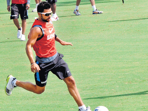 having a ball: Virat Kohli warms-up with a round of football ahead of India's practice session in Jaipur on Tuesday. Pti