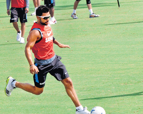 Virat Kohliwarms-up with a round of football ahead of India's practice session in Jaipur on Tuesday. PTI