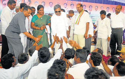 Reaching out: Chief Minister Siddarmaiah being greeted by his supporters at a meet held at Biligere, Nanjangud taluk, Mysore district, on Tuesday.
