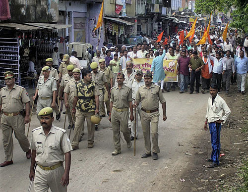 Police keeping a watch as workers of Vishwa Hindu Parishad march during a protest against ban on Sankalp Divas meeting by the Uttar Pradesh government, in Mirzapur on Thursday. PTI Photo