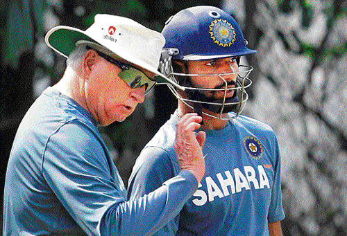 keep it simple: Indian coach Duncan Fletcher (left) discusses a point with Shikhar Dhawan during a practice session at  the Punjab Cricket Association stadium on Friday. pti