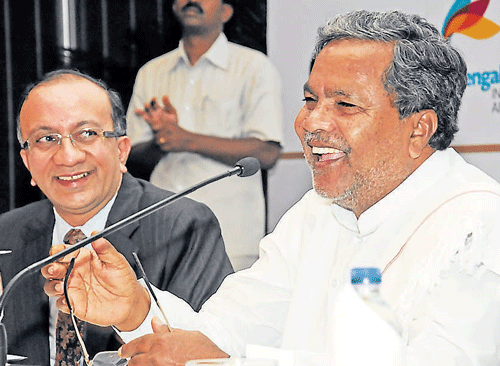 Karnataka Chief Minister Siddaramaiah (right) addresses industrialists at an interactive session in Bangalore on Friday as BCIC President H V Harish looks on. DH&#8200;Photo