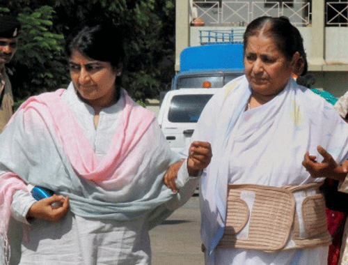 Self-styled godman Asaram Bapu''s wife Laksmi(R) with daughter Bharati(L) come out from Anti Terrorism Squad (ATS) police station in Ahmedabad on Sunday. PTI Photo