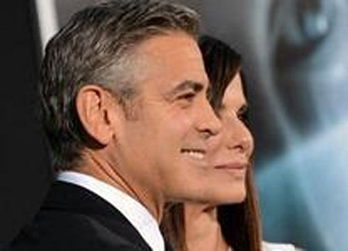Katie Holmes bonds with George Clooney at a friend's dinner party. AP Photo