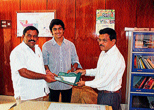 MLA S N Subbareddy receives adoption certificate from Mysore Zoo Executive Director B P Ravi, in Mysore, recently.