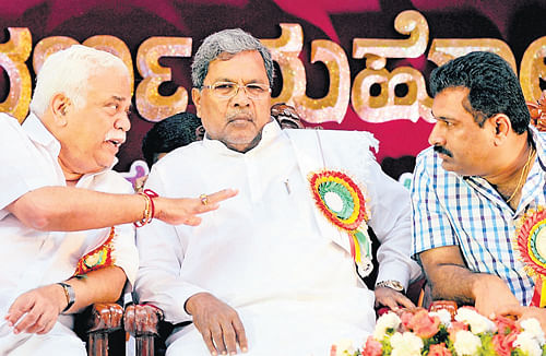 making a point: Chief Minister Siddaramaiah is flanked by Minister for Higher Education and Tourism R V Deshpande and MLC Puttanna at the golden jubilee celebrations of  Government Polytechnic For Women in the City on Monday.  dh photo