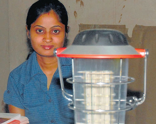 GREEN PROPONENT A participant at the Green Energy Fair at Basava Bhavan shows off her renewable energy device on Monday. DH photo