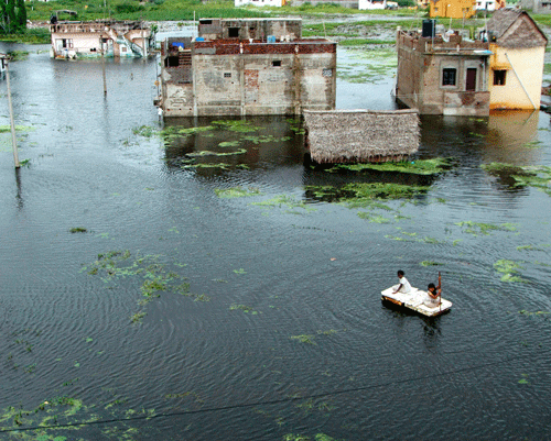 A flooded locality on the outskirts of Chennai after heavy rain on Monday. PTI