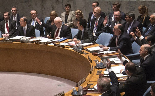 United Nations Security Council raise their hands as they vote unanimously to approve a resolution eradicating Syria's chemical arsenal at a Security Council meeting in New York. AP File Photo
