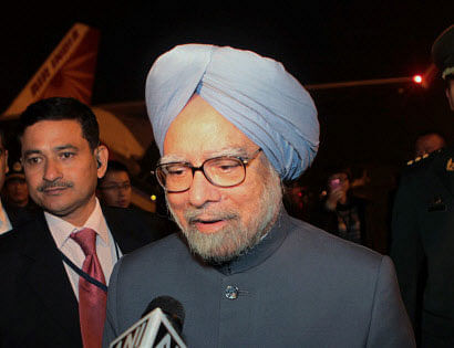 Prime Minister Manmohan Singh talks to the media on his arrival at Beijing International Airport in China on Tuesday. PTI Photo