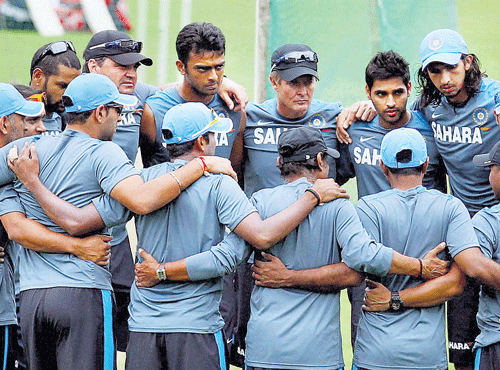 huddle time: Indian cricketers discuss a point ahead of their practice session at Ranchi on Tuesday. India will face Aussies in the fourth ODI on Wednesday. pti