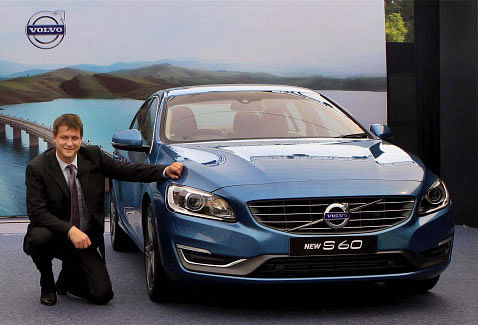 Managing Director of Volvo Auto India, Tomas Ernberg poses with the newly launched 'New Volvo S 60' car in New Delhi on Wednesday. PTI Photo