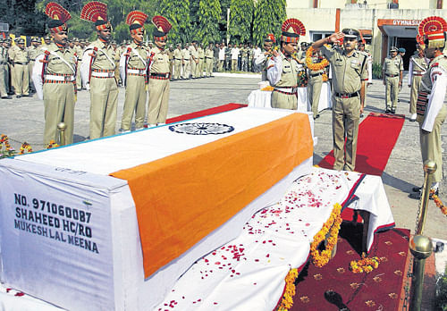 LAST SALUTE: BSF officers pay tribute to soldier Mukeshlal Meena, who was killed in RS Pura Sector in a shootout by Pakistan, during a wreath laying ceremony in Jammu on Wednesday.  PTI