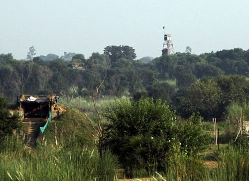 An Indian security picket and a Pakistani security watch tower are pictured along the border between India and Pakistan in Samba sector / reuters file photo