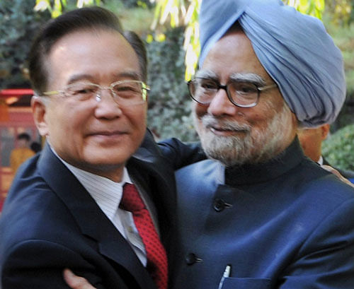 Prime Minister Manmohan Singh greets the former Chinese Premier Wen Jiabaoa, at a meeting in Beijing, China on Thursday. PTI Photo