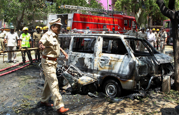 Police personnel inspect the site of the blast near the BJP office at Malleswaram in Bangalore. File PTI Image