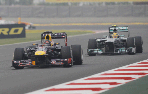 Red Bull driver Sebastian Vettel of Germany leads Mercedes driver Lewis Hamilton of Britain during the second practice session at the Indian Formula One Grand Prix at the Buddh International Circuit in Noida, India, Friday, Oct. 25, 2013. AP photo
