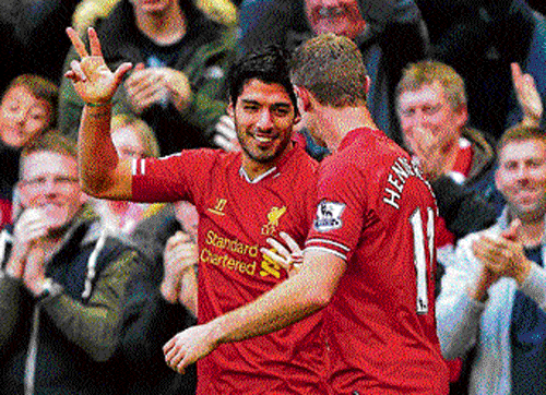 Back in form: Liverpool's Luis Suarez celebrates after  scoring against West Bromwich Albion on Saturday. ap