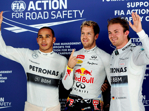 Three fastest drivers Red Bull's Sabastian Vettel (C), Mercedes AMG Petronas' Nico Roseberg and (R) Lewis Hamilton pose after the post qualifying session of the 2013 Formula 1 Indian Grand Prix at BIC in Greater Noida on Saturday. PTI Photo
