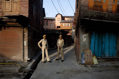 Policemen stand guard during a strike in Srinagar. AP file photo
