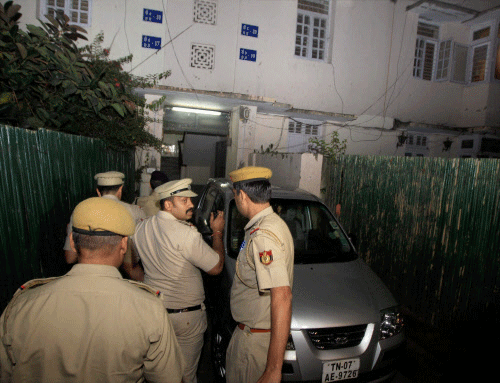Policemen outside the house of a central government employee and his wife who were found dead at their residence in New Delhi on Friday. PTI Photo