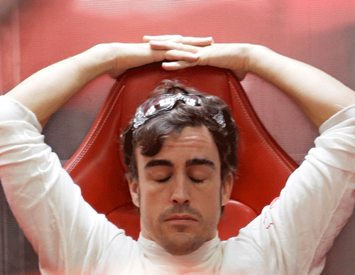 Ferrari Formula One driver Alonso closes his eyes during the third practice session of the Indian F1 Grand Prix at the Buddh International Circuit in Greater Noida. Reuters