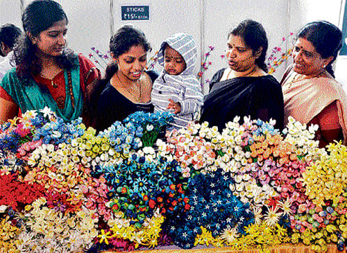Green wonders: Women appreciate flowers made of cocoons during the inauaguration of Urban Krishi Mela at University of Agricultural Sciences in Bangalore on Sunday. dh photo