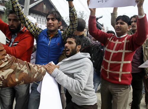 A policeman detains an activist of Democratic Freedom Party during a protest in Srinagar on Sunday, Oct. 27, 2013. Separatists groups in Kashmir called a general strike Sunday to mark the anniversary of the day Indian troops took control of the region in 1947. AP Photo