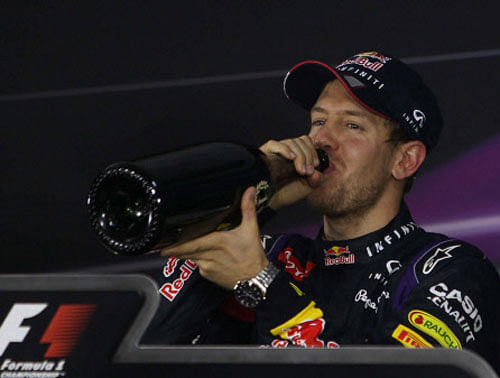 Red Bull driver Sebastian Vettel drinks champagne during a press conference after winning the Indian Formula One Grand Prix at Buddh International Circuit in Greater Noida on Sunday. PTI Photo
