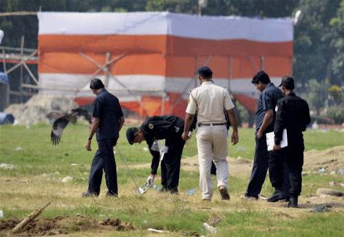 NSG commandos collecting samples from Gandhi maidan after it was rocked by bomb blasts during Narendra Modi's Hunkar rally on Monday in Patna. PTI Photo